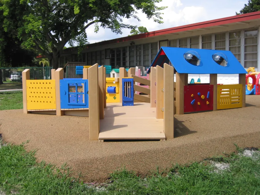 a small play structure outside of a building