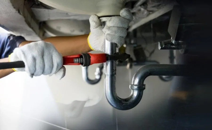 a person wearing gloves and a white lab coat holding a pipe