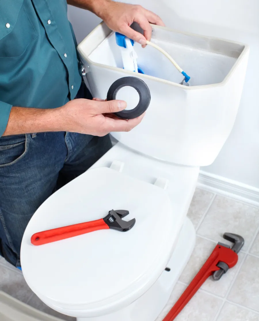 a person washing a toilet