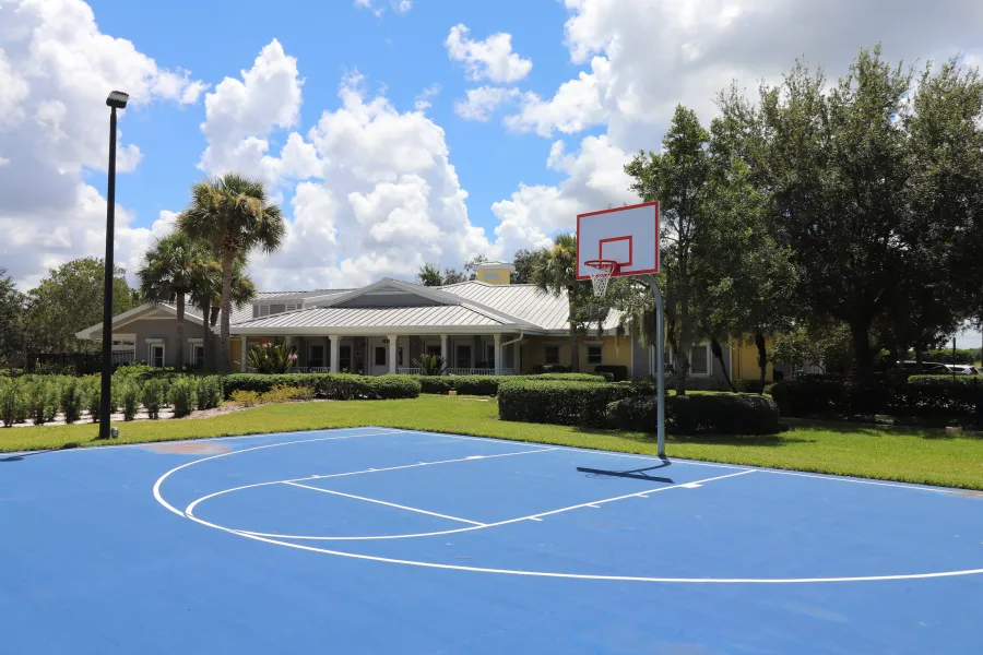 a tennis court in front of a building