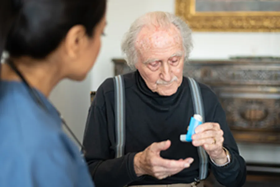 a man holding a pen and a woman looking at him