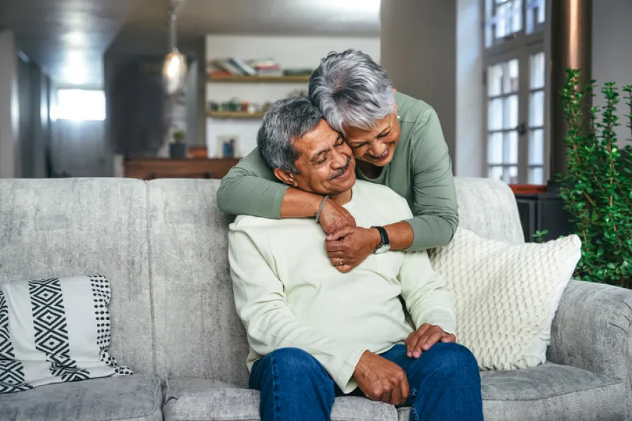 a man and woman embracing on a couch