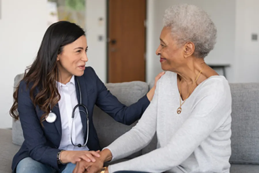 a woman sitting next to a woman