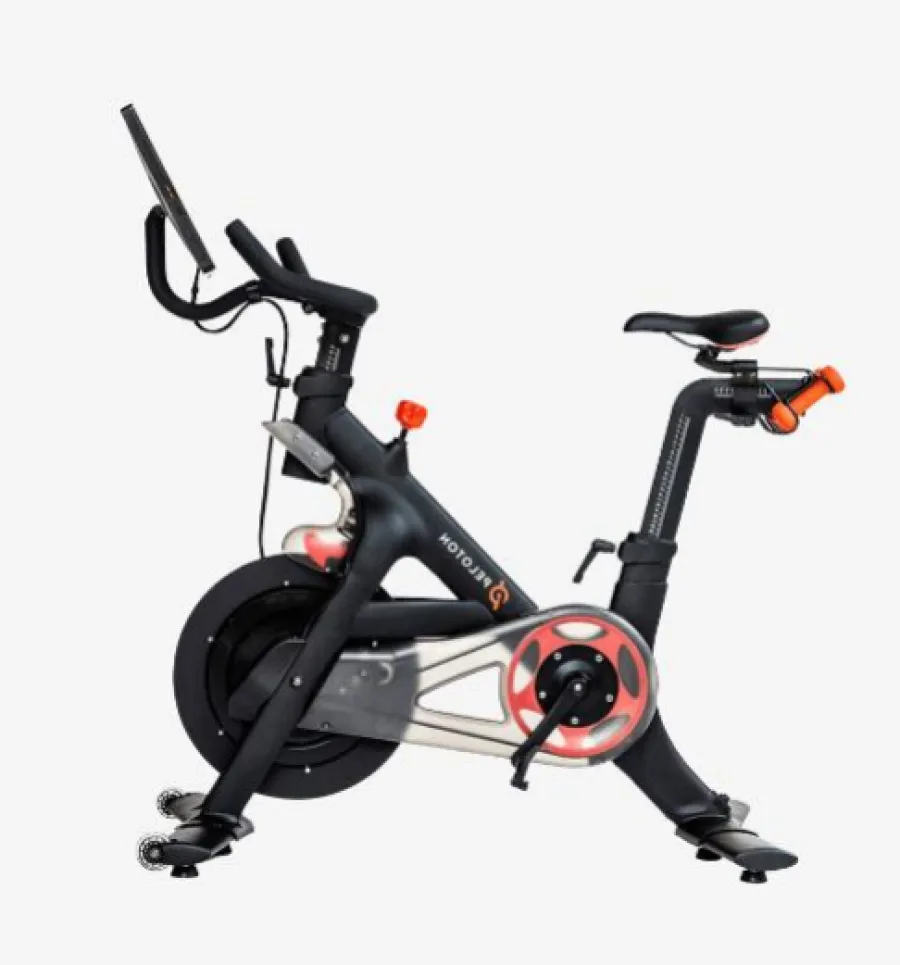 Black stationary exercise bike with digital screen, adjustable seat, pedals, and resistance adjustment knob.