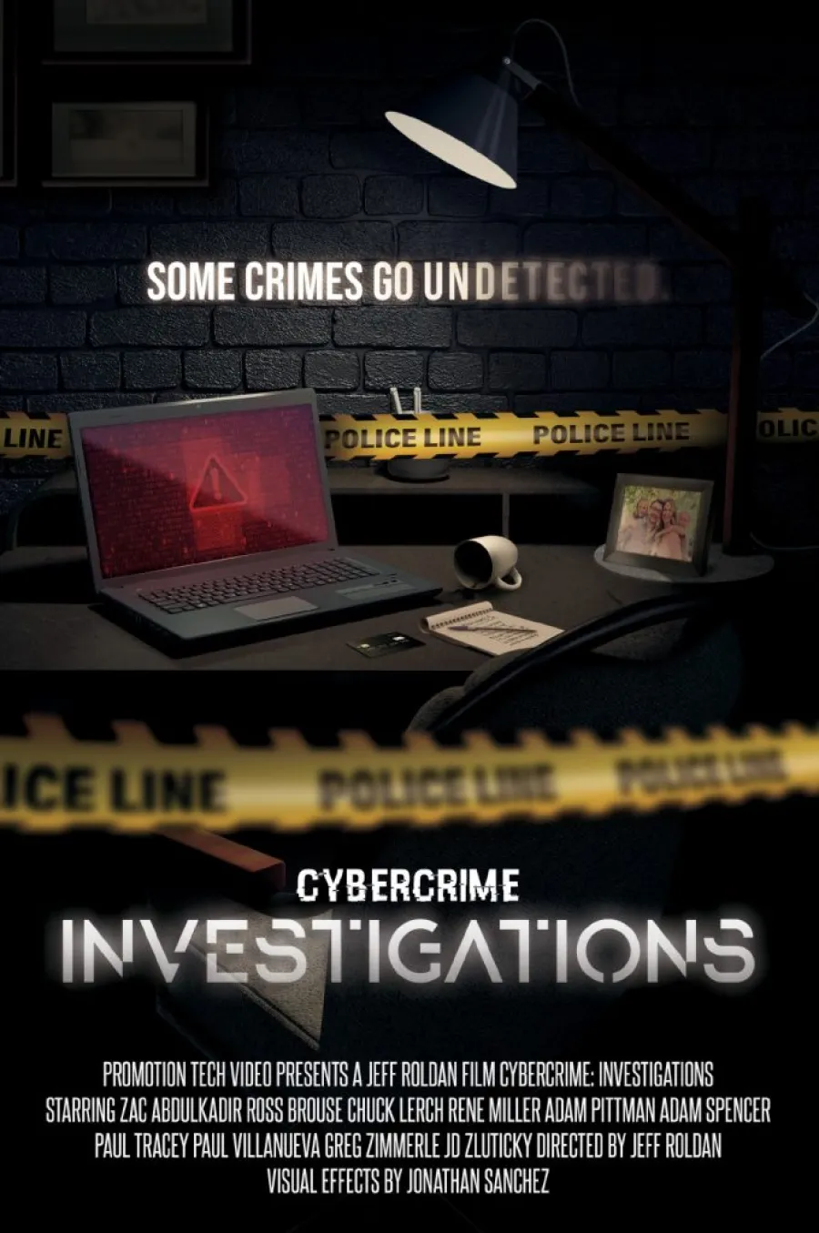 Dark room with laptop showing warning, police tape, lamp, and text about cybercrime investigations on brick wall.