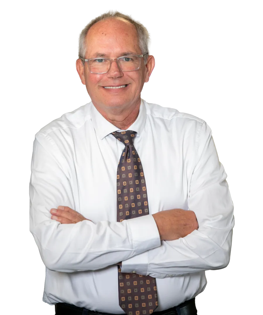 Smiling mature man in white shirt and patterned tie with arms crossed on black background