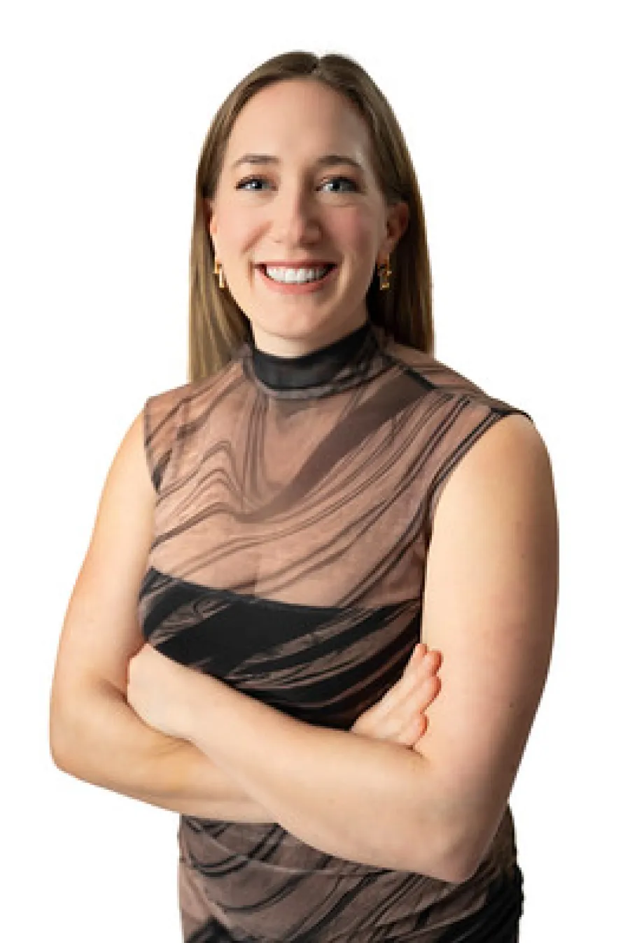 Smiling woman with crossed arms wearing a black and brown patterned sleeveless top against white background