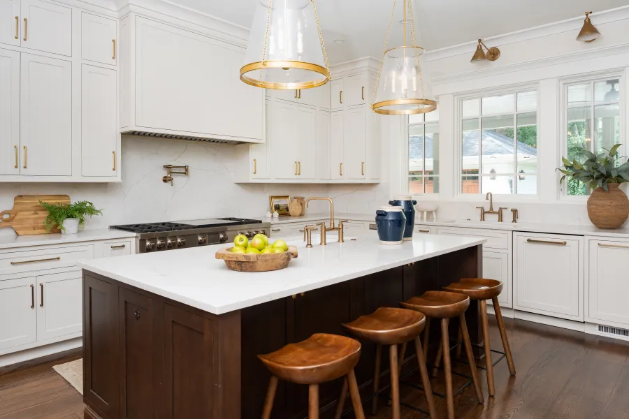 Modern kitchen with white cabinets, elegant island, and warm wooden accents, bright and inviting atmosphere.