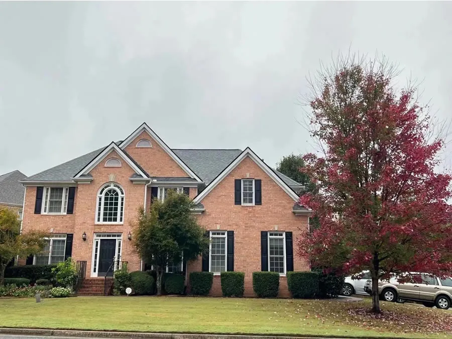 a brick building with a tree in front of it