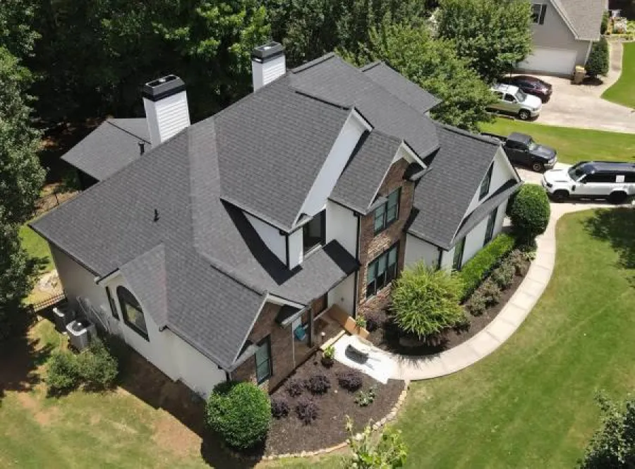 a house with a driveway and cars parked in the driveway