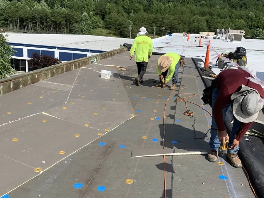 a group of people working on a solar panel