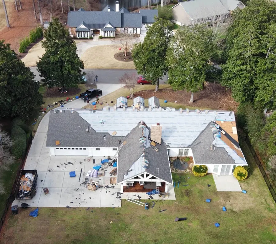 a house with a pool and trees around it