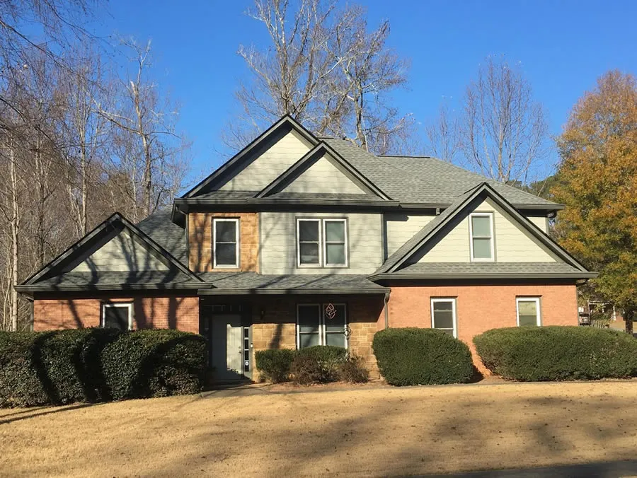 a house with bushes in front of it