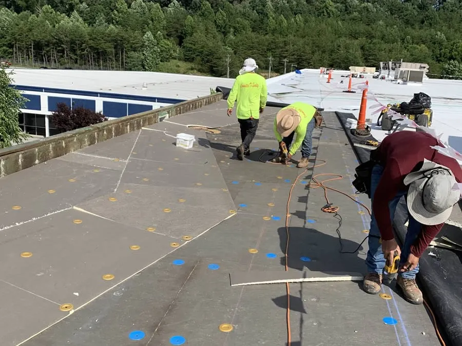 a group of people working on a solar panel