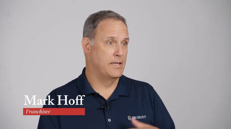 Man named Mark Hoff speaking in a navy shirt with Sir Grout logo against a plain gray background.