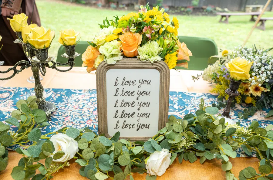A feast table decorated with yellow flowers