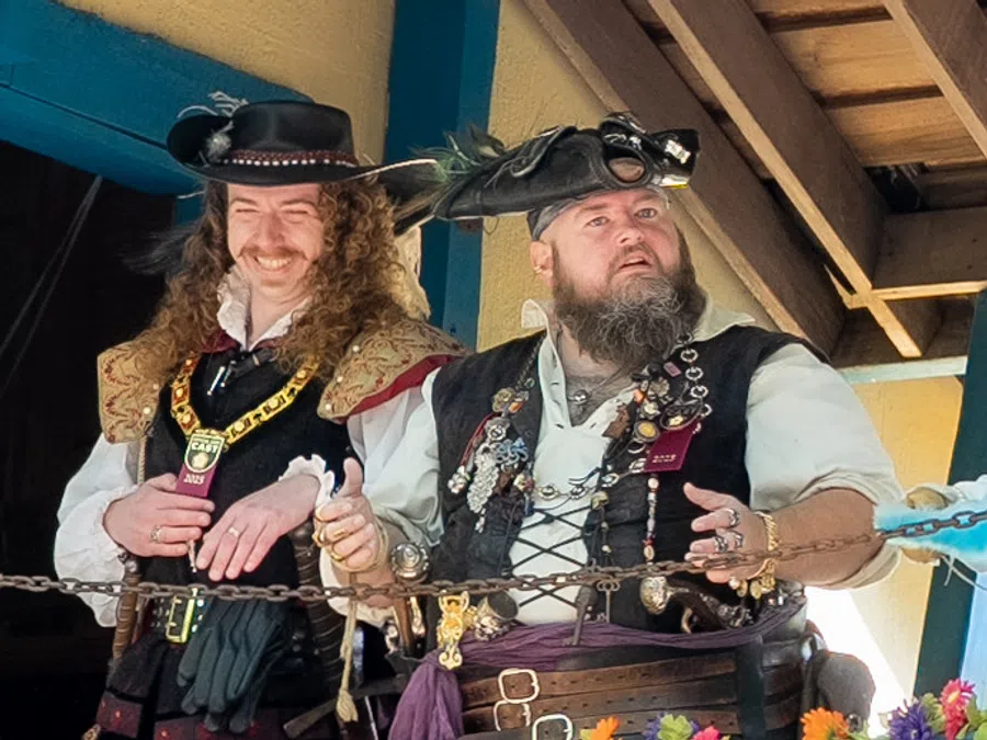 Two male performers on an elevated catwalk stage at the Festival.