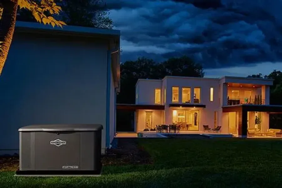 A portable generator peacefully illuminates a modern home at dusk, surrounded by trees.