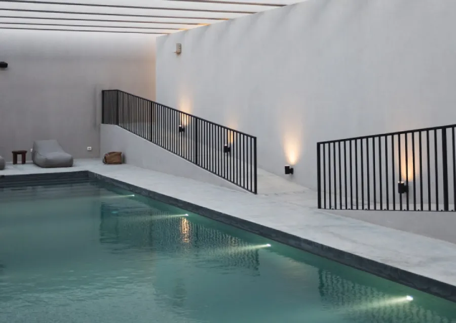 a swimming pool with a white wall