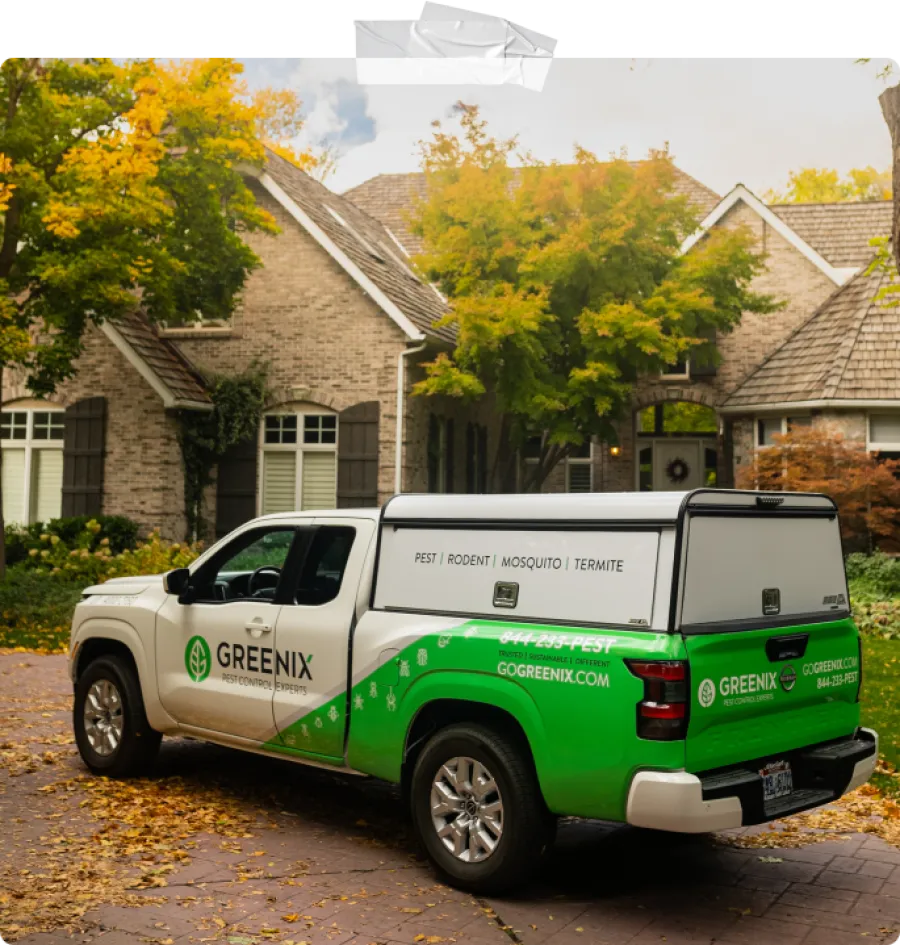 a greenix truck parked in front of a house