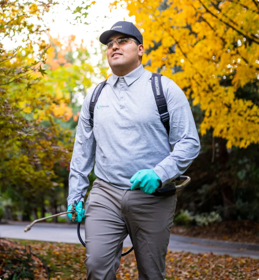 Pest Technician walking with pest spray