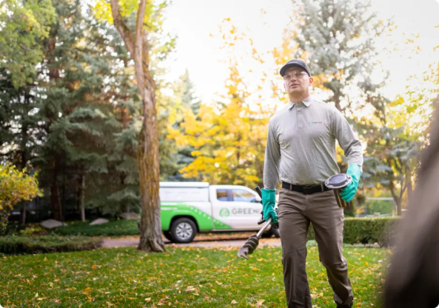 Pest Technician walking to house with tools