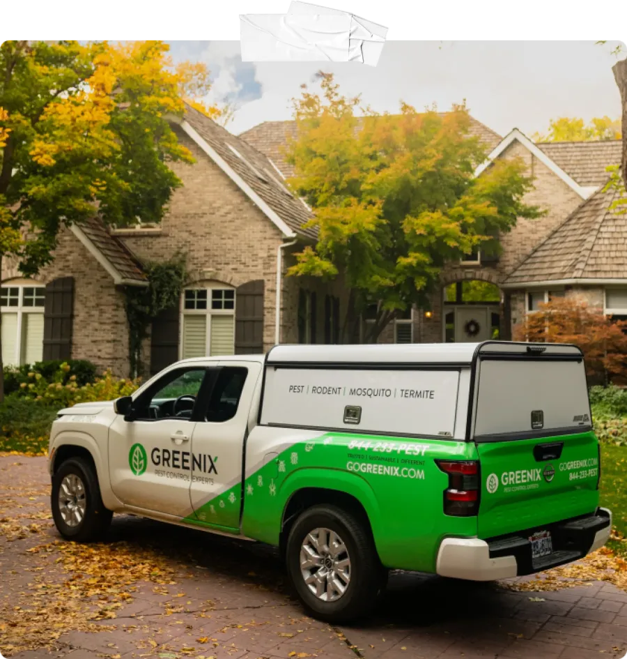 a Greenix truck parked in front of a house