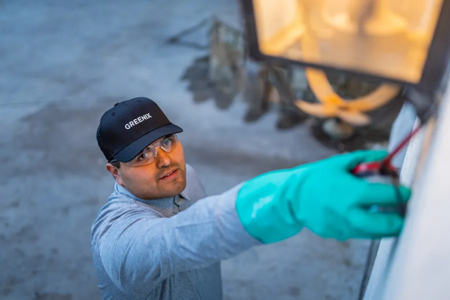 a pest control technician wearing a hat and gloves