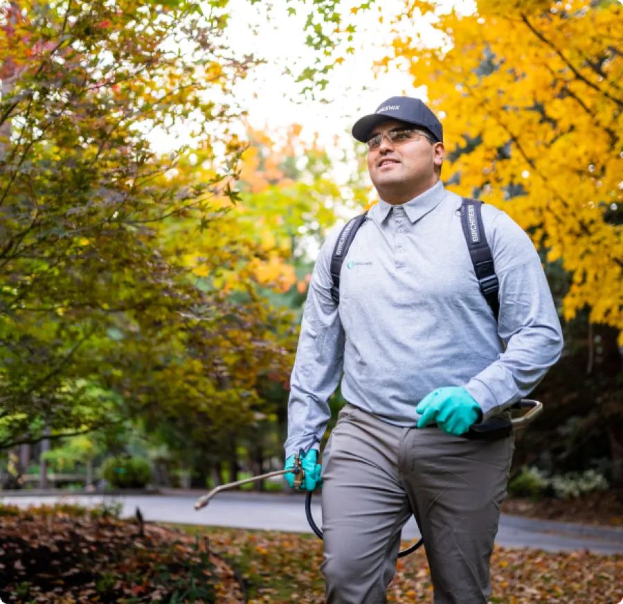 Pest Technician walking to house with tools