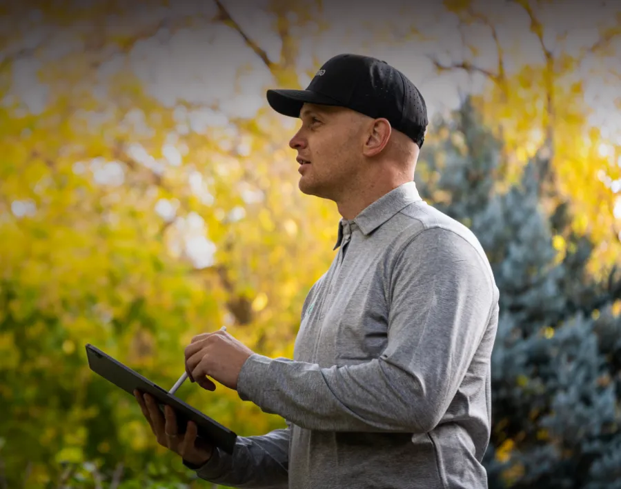 Pest technician holding tablet for pricing