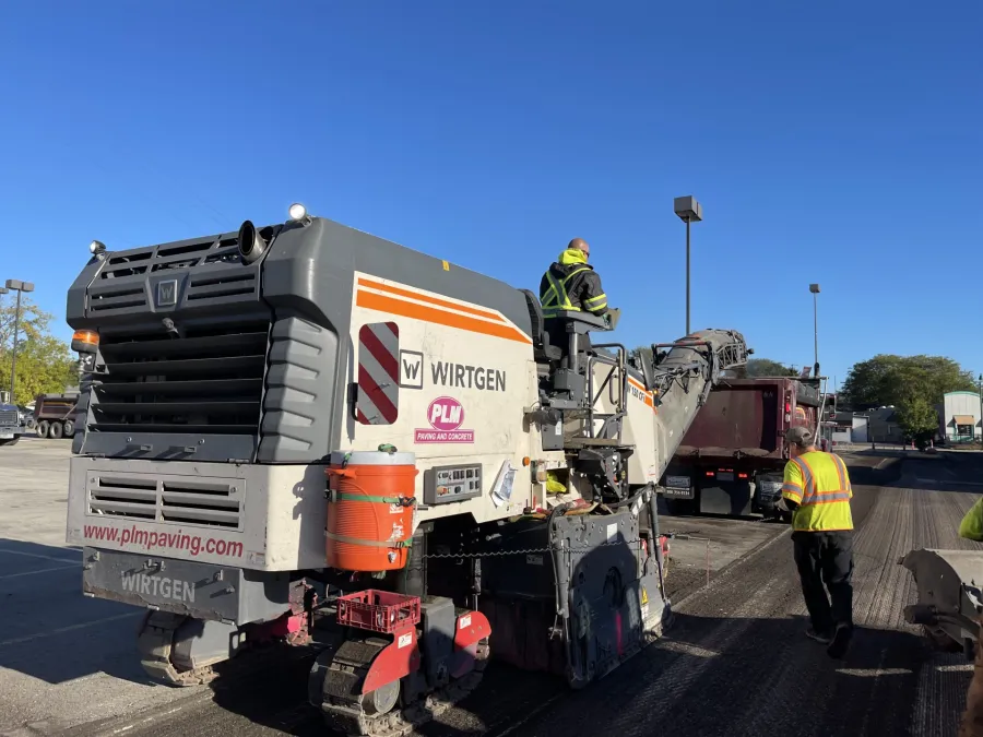 a couple of men standing on a large truck