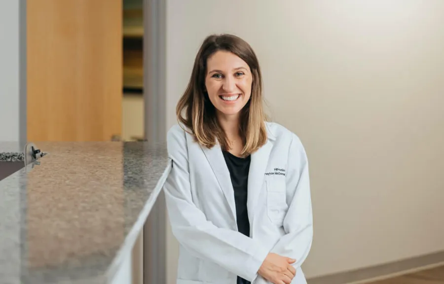 a woman in a white coat