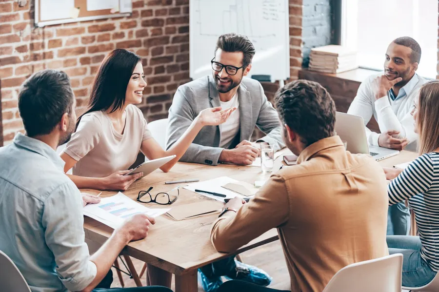 a group of people sitting around a table