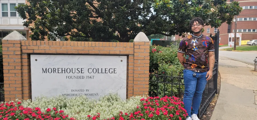 a person standing next to a sign