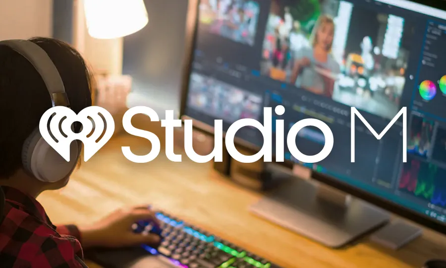Person using a computer with video editing software displayed and Studio M logo overlayed.