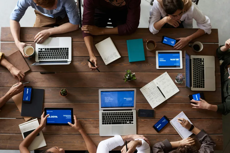 a group of people working on their laptops