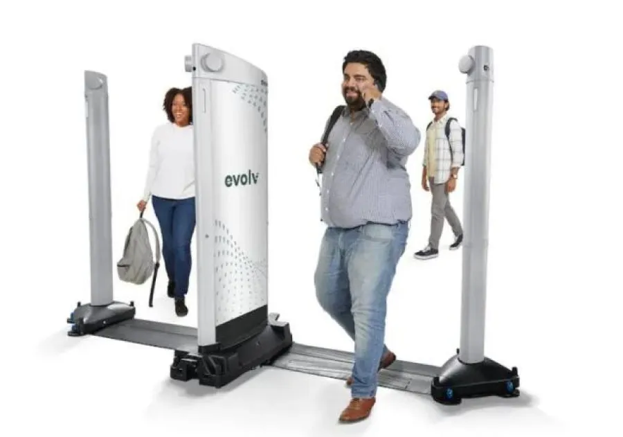 a few people standing next to a machine