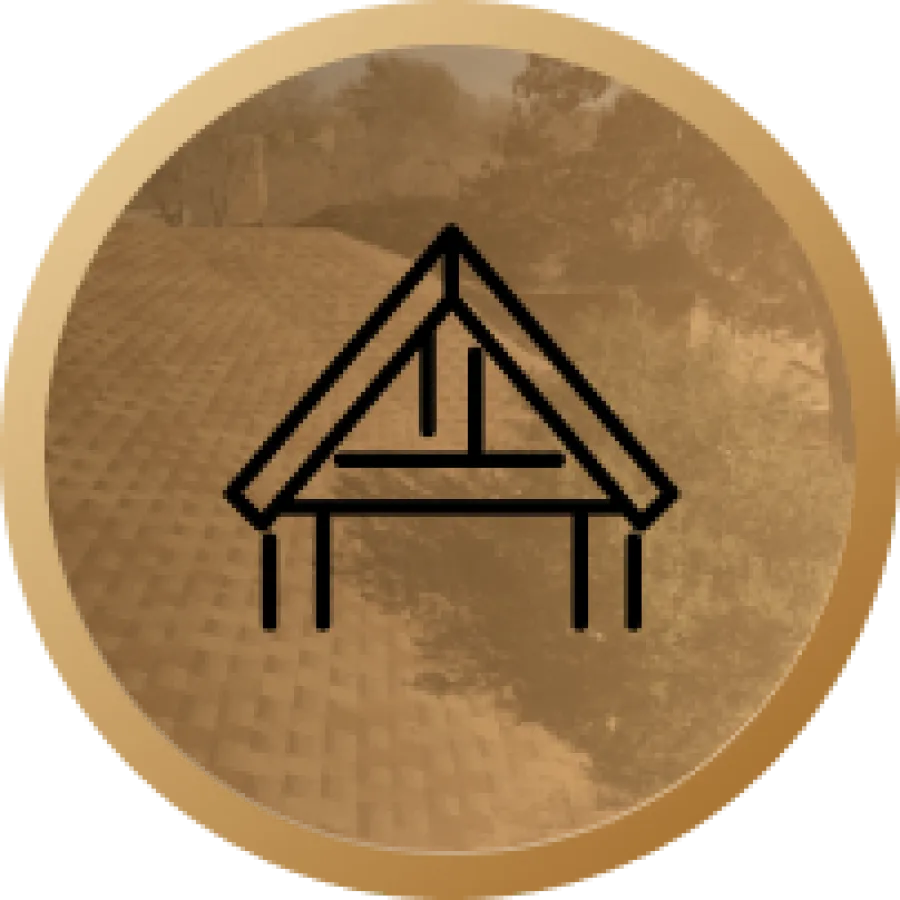 Black house roof outline icon centered on a circular golden background with a textured roof and trees faintly visible.