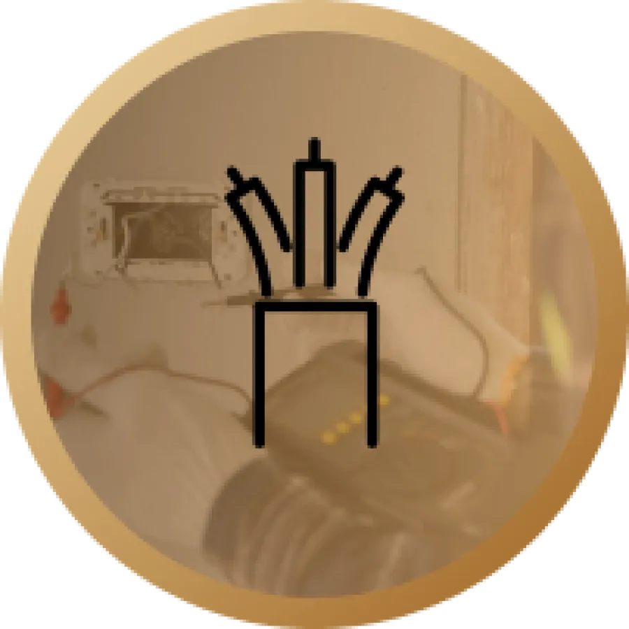 Black icon of a cable with three wires inside a golden circular background with a blurred electrical device.