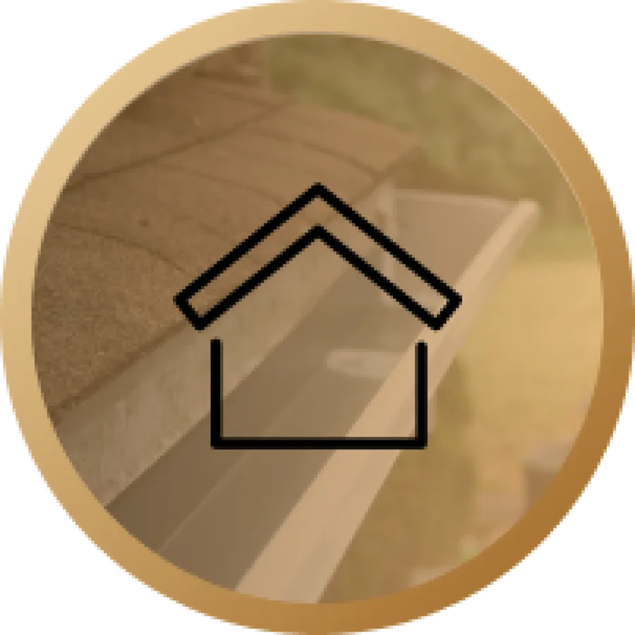 Close-up of a roof edge with asphalt shingles and a clean white rain gutter with blurred background