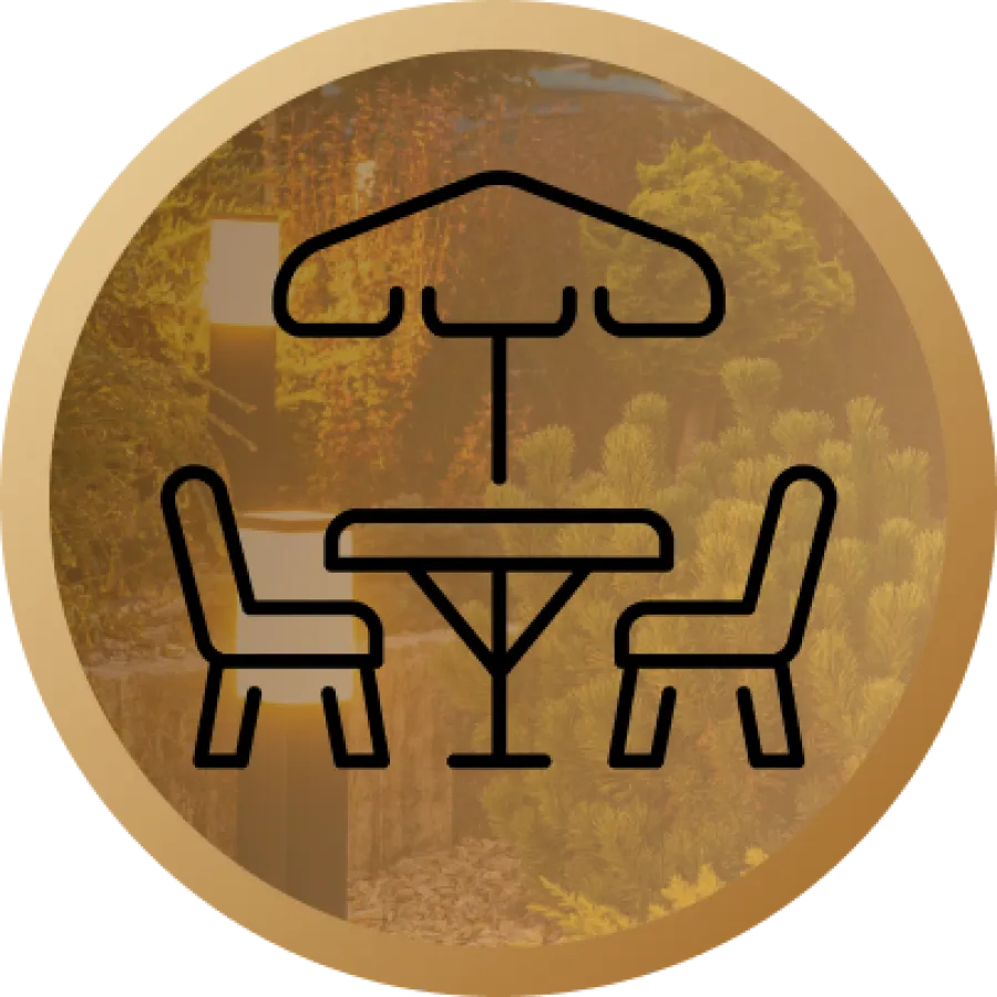 Icon of outdoor umbrella table with two chairs against a garden background in a gold circle.