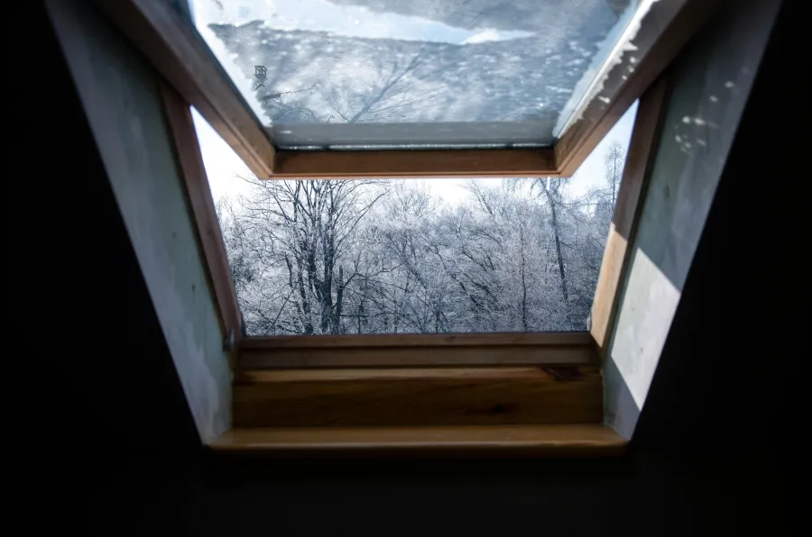 a skylight window with snow outside