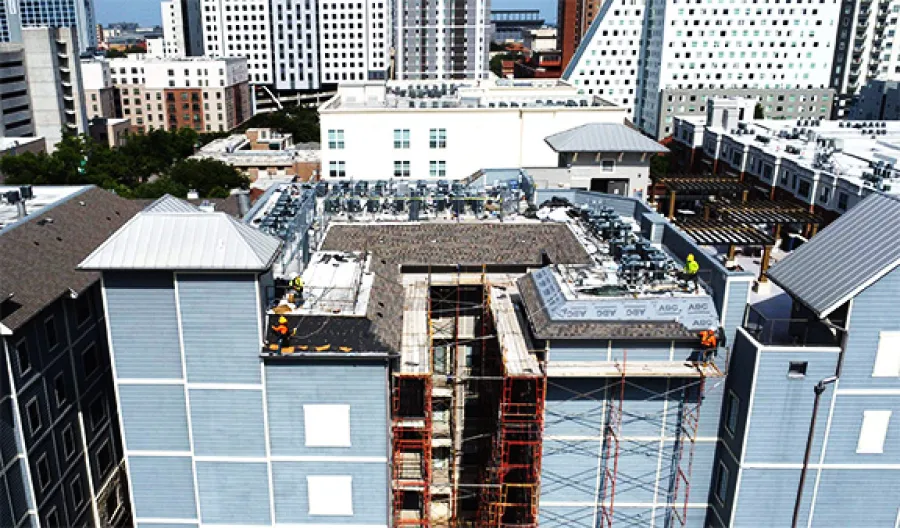 Aerial view of Mattco Roofing and Construction crew installing roofing system on The Block on Pearl South student housing complex in Austin Texas