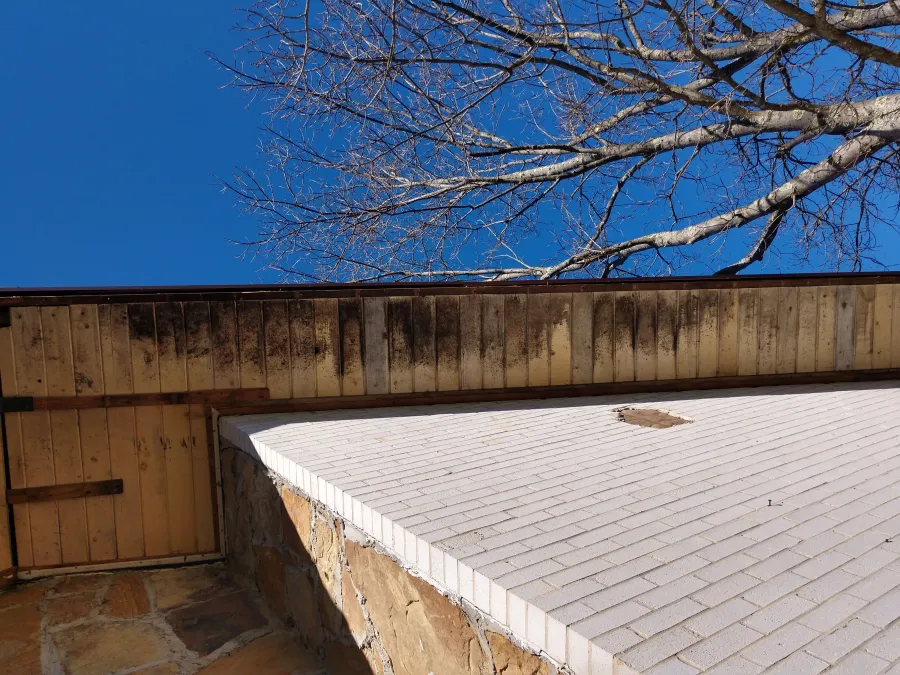 Technician organizing tools inside a white work van with shelves and storage boxes