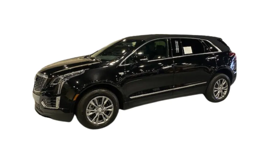 Sleek black Cadillac XT5 SUV displayed at an auto show, showcasing its modern design and luxury features.