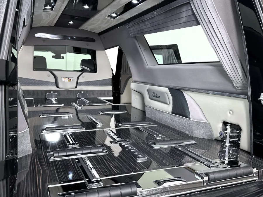 Luxurious black and grey Cadillac Platinum hearse interior with polished wood and chrome accents