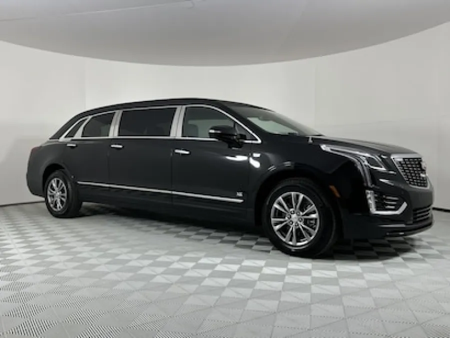 Sleek black Cadillac limousine displayed in a modern showroom setting.