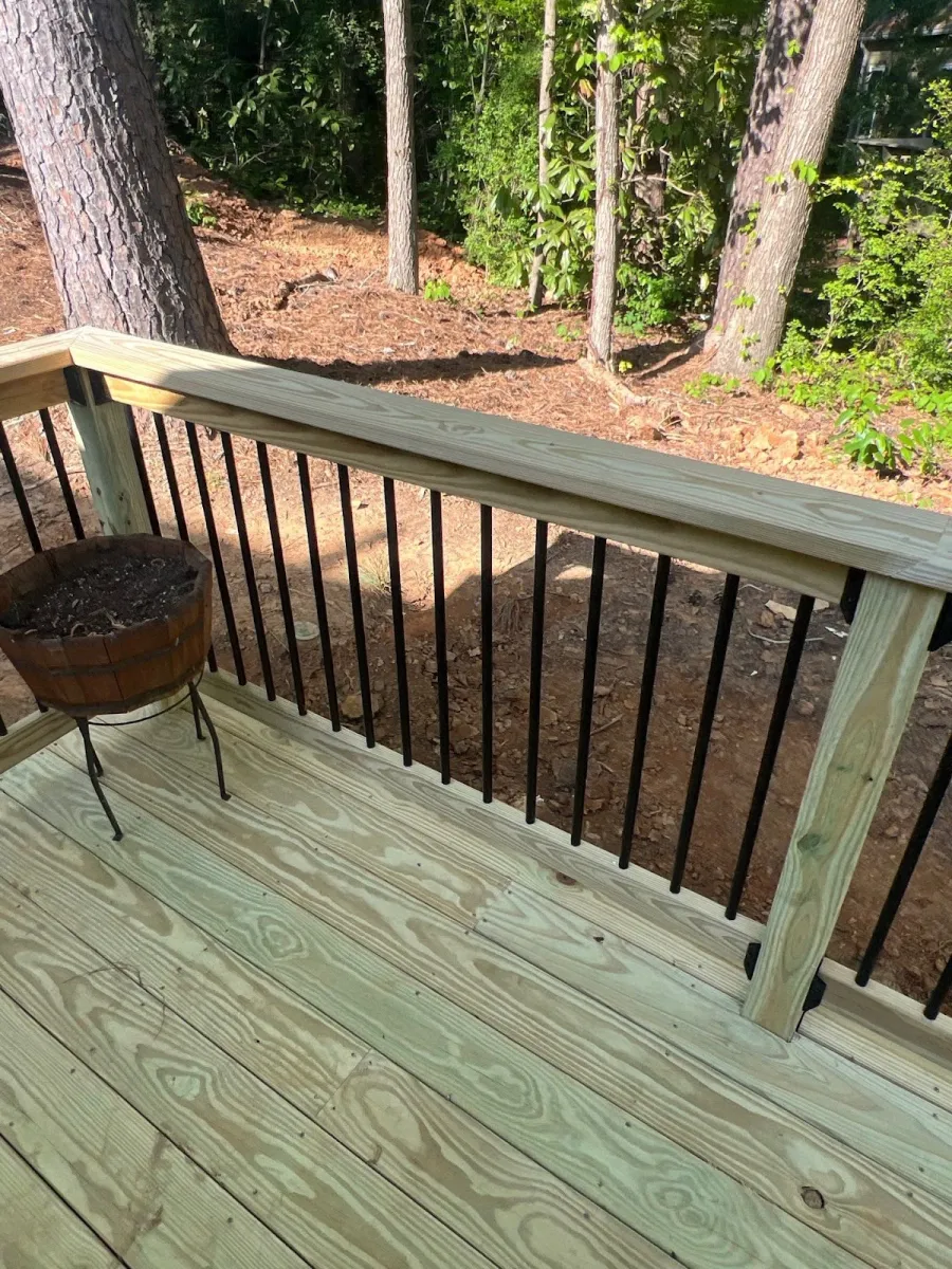 Close-up of a beige house exterior with dormer windows and gray shingles on a sunny day.