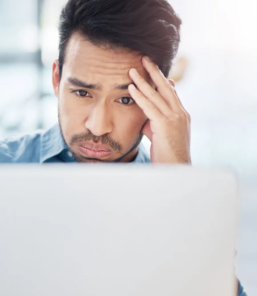 a man looking at a laptop