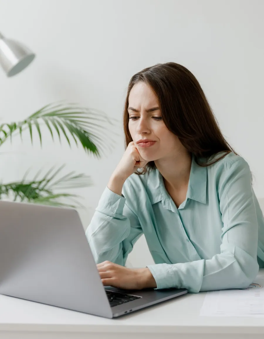 a woman sitting at a table with a laptop